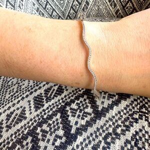 Delicate white gold and diamond clasped bangle